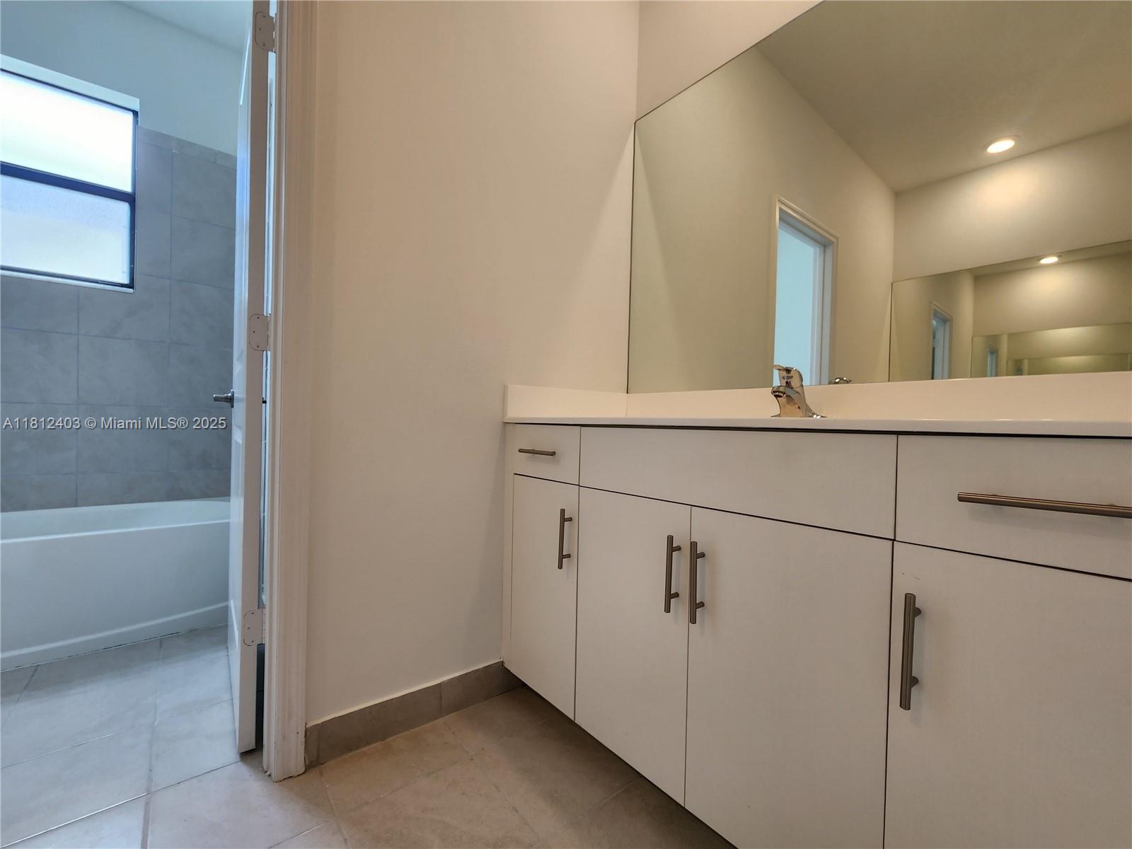 12959 Southwest 229th Lane Miami, FL 33170 - Photo 23 of 28 a bathroom with a sink and mirror