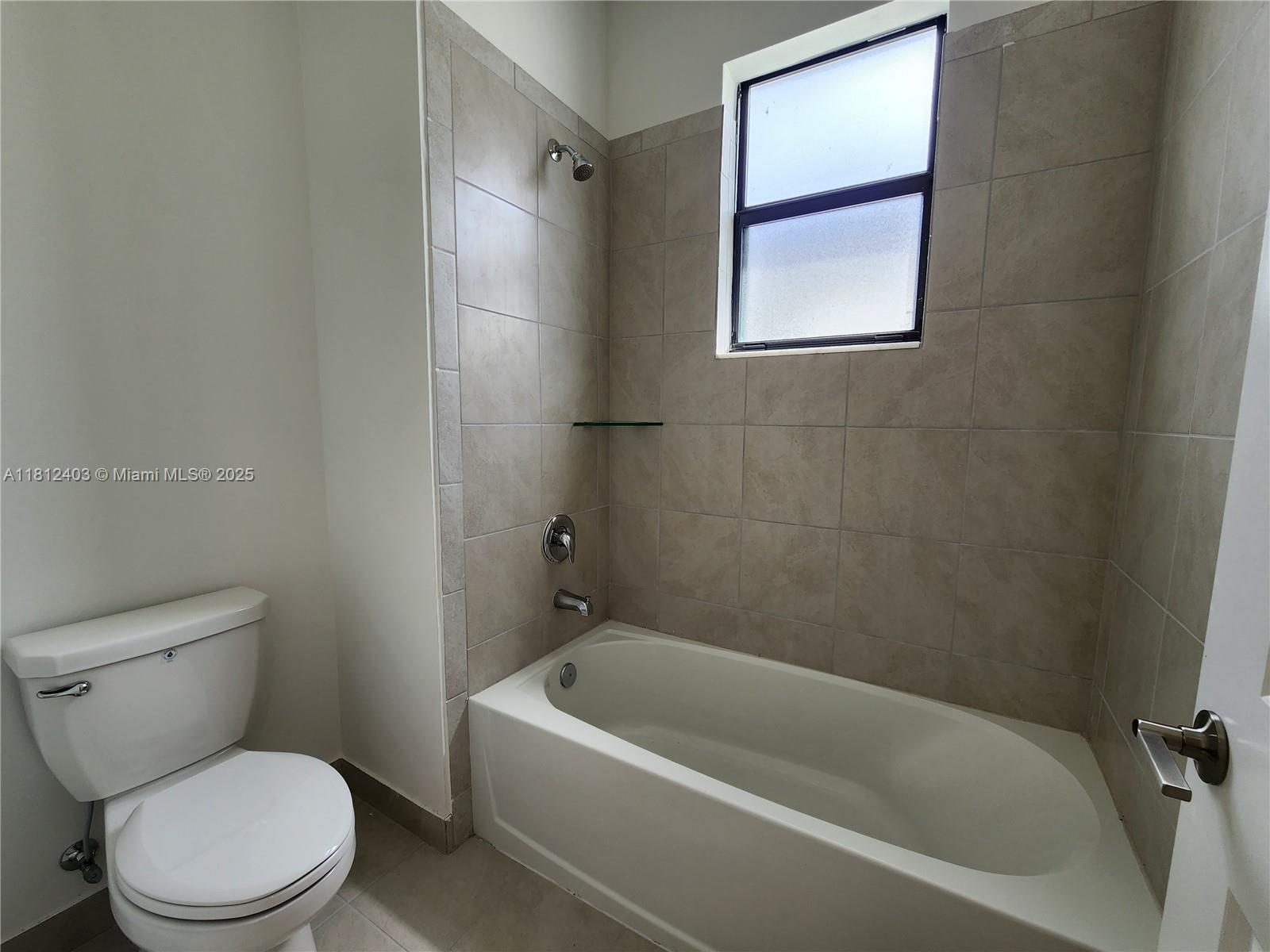 12959 Southwest 229th Lane Miami, FL 33170 - Photo 24 of 28 a white toilet sitting next to a bath tub