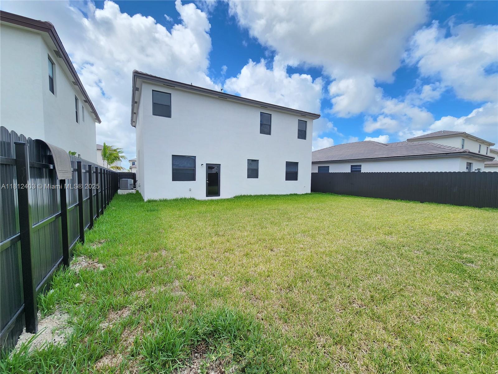 12959 Southwest 229th Lane Miami, FL 33170 - Photo 26 of 28 a view of a house with a yard and a large tree