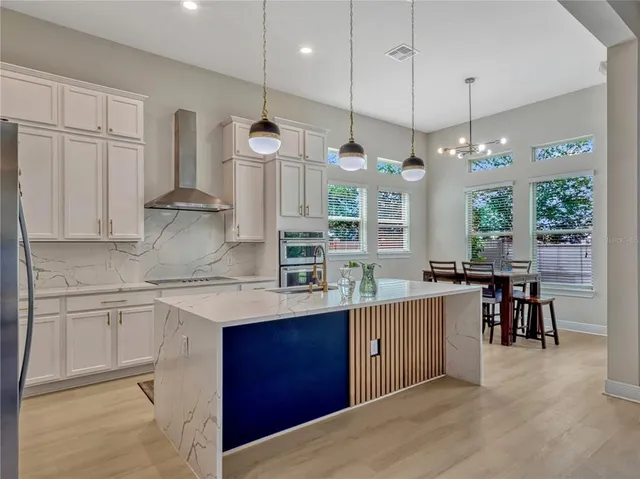 a kitchen with lots of counter space and a chandelier