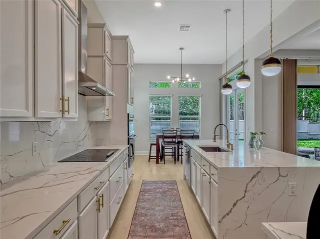 a kitchen with counter top space and dining table