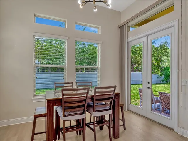 a dining room with furniture and a window