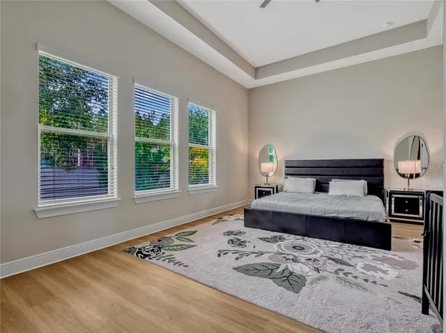 a bedroom with a bed lamp and a window