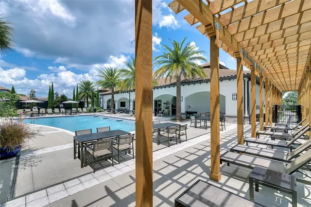a view of a patio with table and chairs under an umbrella with a patio