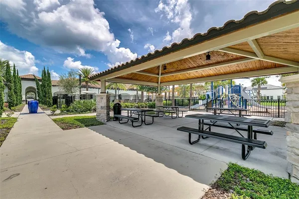 a view of a house with pool and chairs