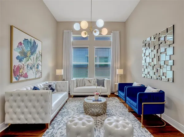 a living room with furniture flowerpot and window
