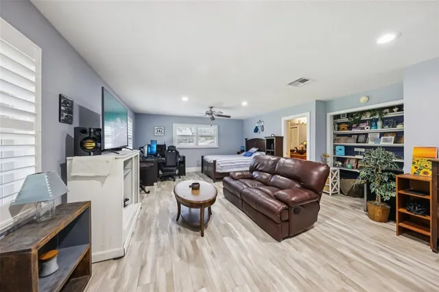 a living room with furniture and a wooden floor
