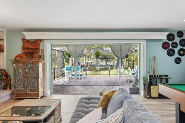 a living room with furniture and a floor to ceiling window