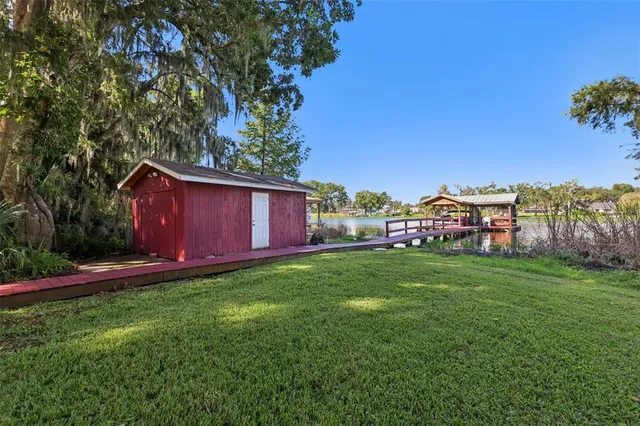 a view of a yard with an tree and a fence