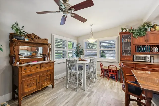a dining room with furniture window and wooden floor
