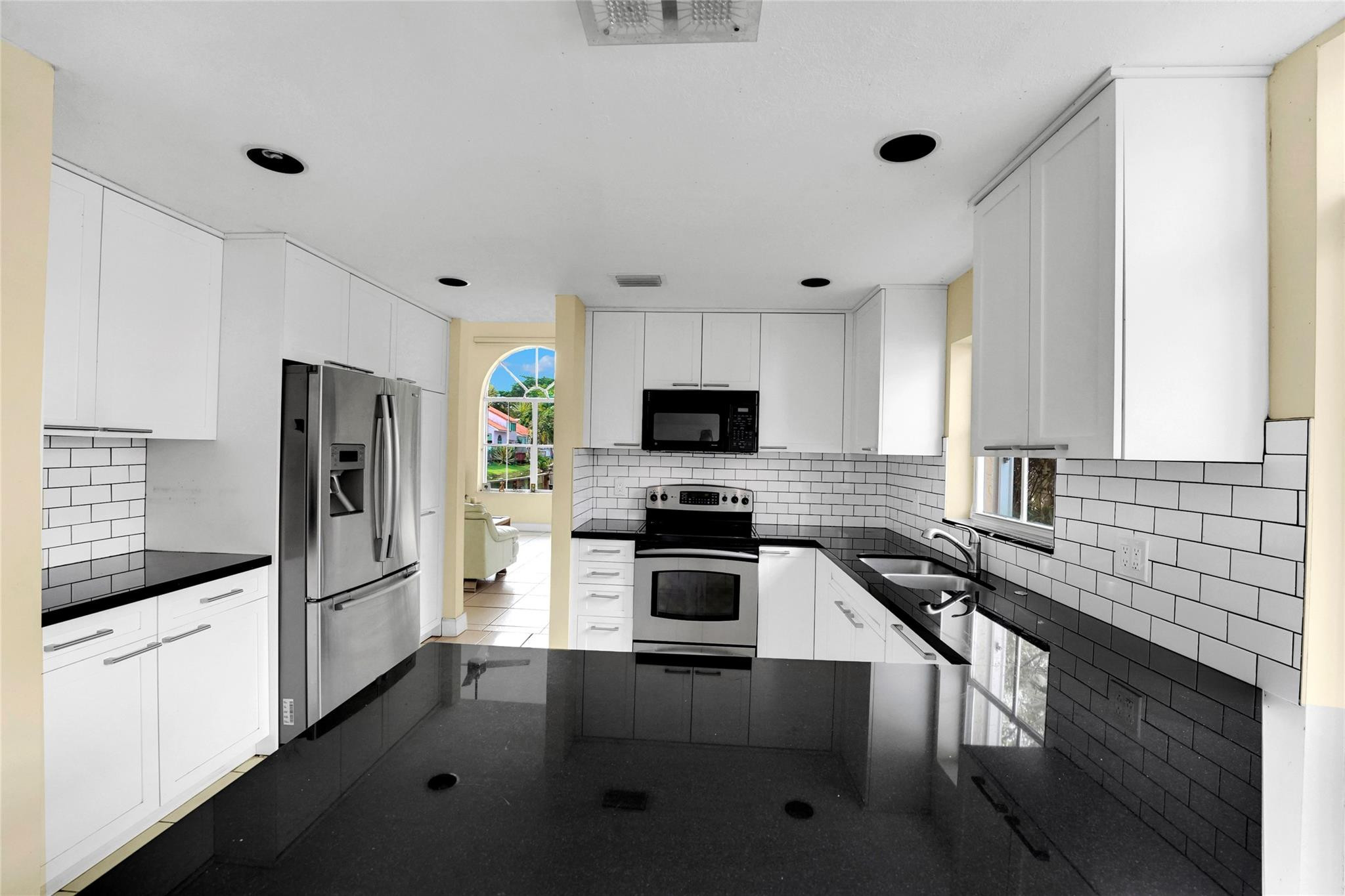 3130 North 38th Avenue Hollywood, FL 33021 - Photo 14 of 42 a kitchen with granite countertop a refrigerator stove and microwave