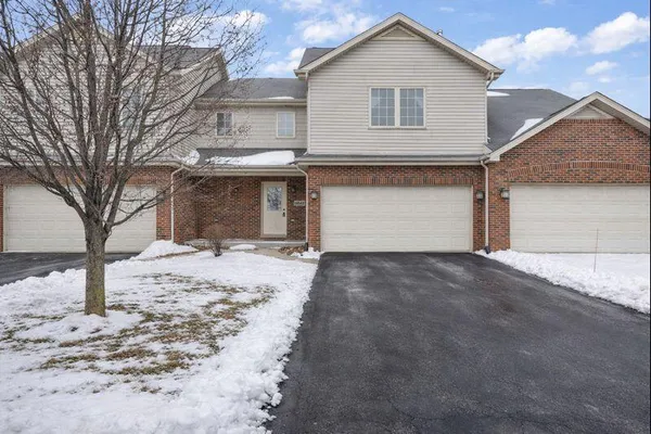 a view of a white house with a yard covered in snow