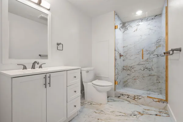 a bathroom with a toilet sink and shower