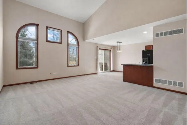 a view of an empty room with a window and fireplace
