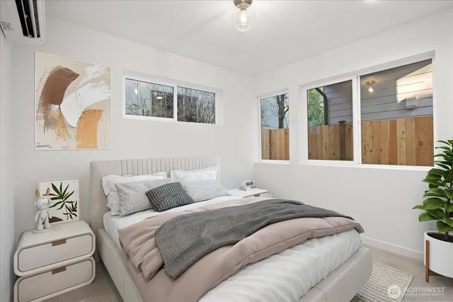 a bedroom with a bed and a painting on the wall