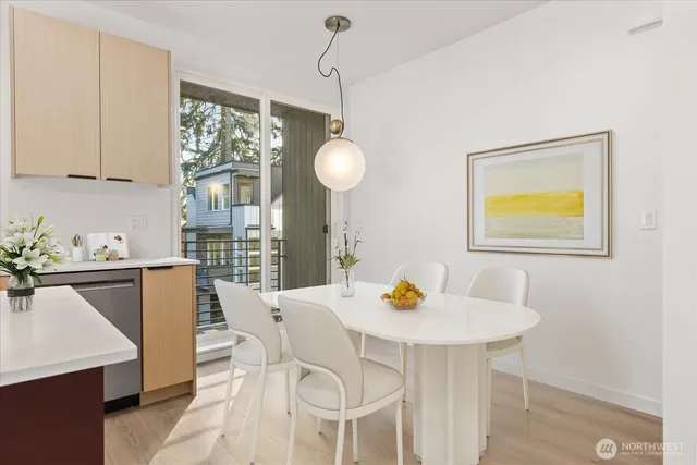 a view of a dining room with a table and chairs
