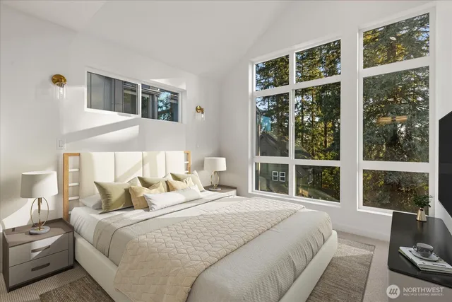 a bedroom with bed and a large window