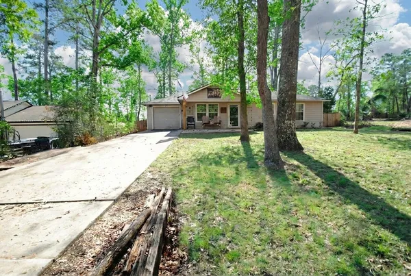 a backyard of a house with table and chairs
