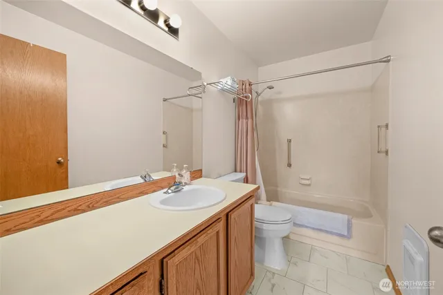 a bathroom with a sink a toilet and a mirror