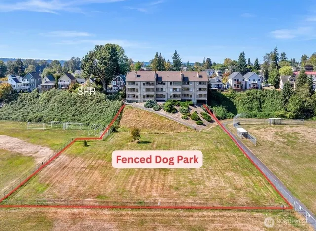 an aerial view of residential houses with outdoor space and lake view