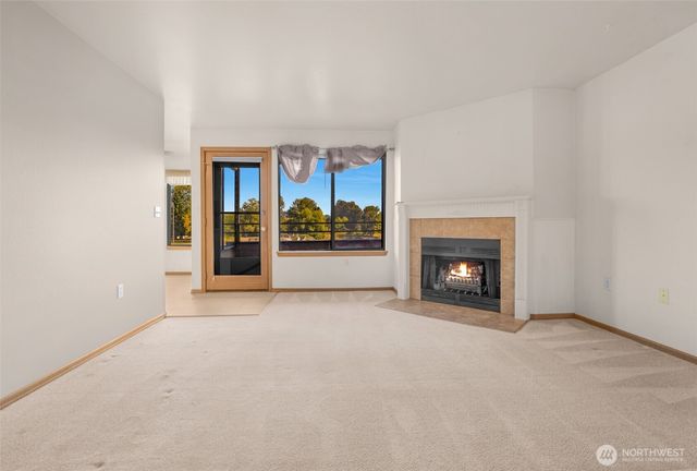 an empty room with furniture and fireplace