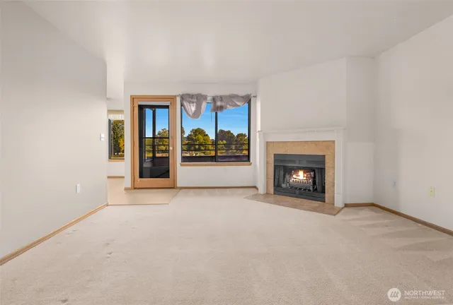 an empty room with furniture and fireplace