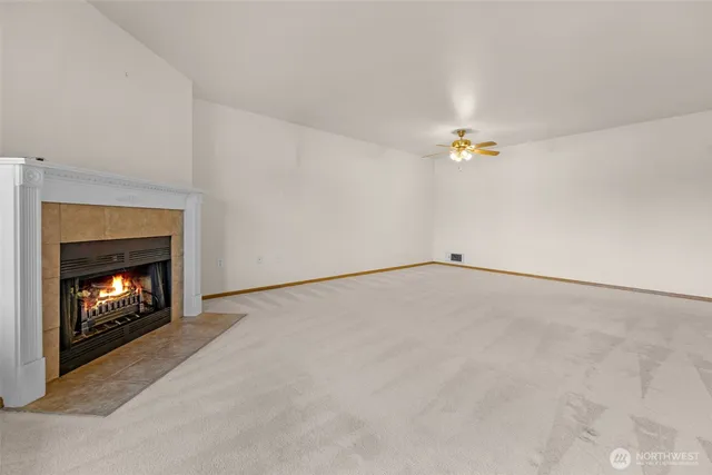 a view of an empty room with a fireplace