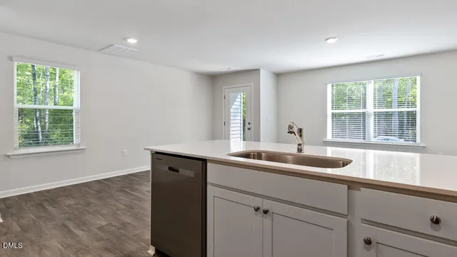 a kitchen with a sink and large window