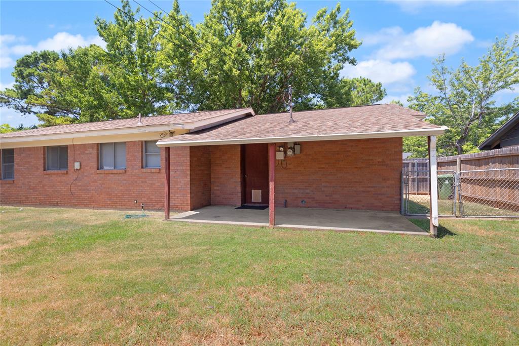 1332 Harrison Lane Hurst, TX 76053 - Photo 5 of 33 Covered back patio with a flat grassed area.