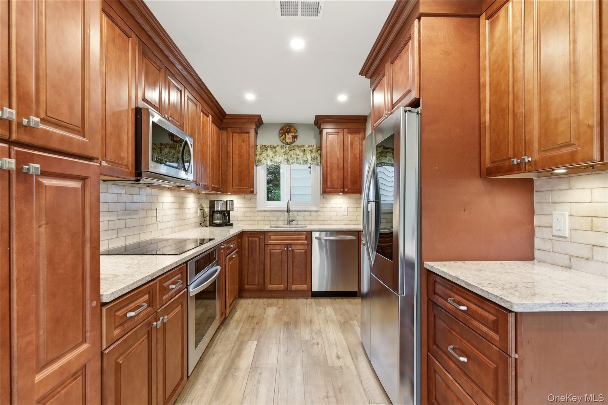 44 Hidden Ridge Drive Syosset, NY 11791 - Photo 6 of 28 a kitchen with stainless steel appliances granite countertop wooden cabinets a sink dishwasher a stove and a refrigerator