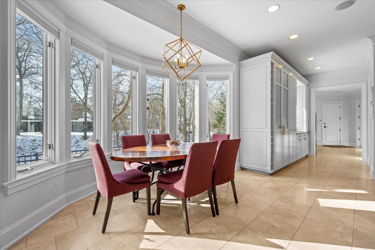 697 Bluff Road Lake Bluff, IL 60044 - Photo 11 of 49 a view of a dining room with furniture a chandelier and wooden floor