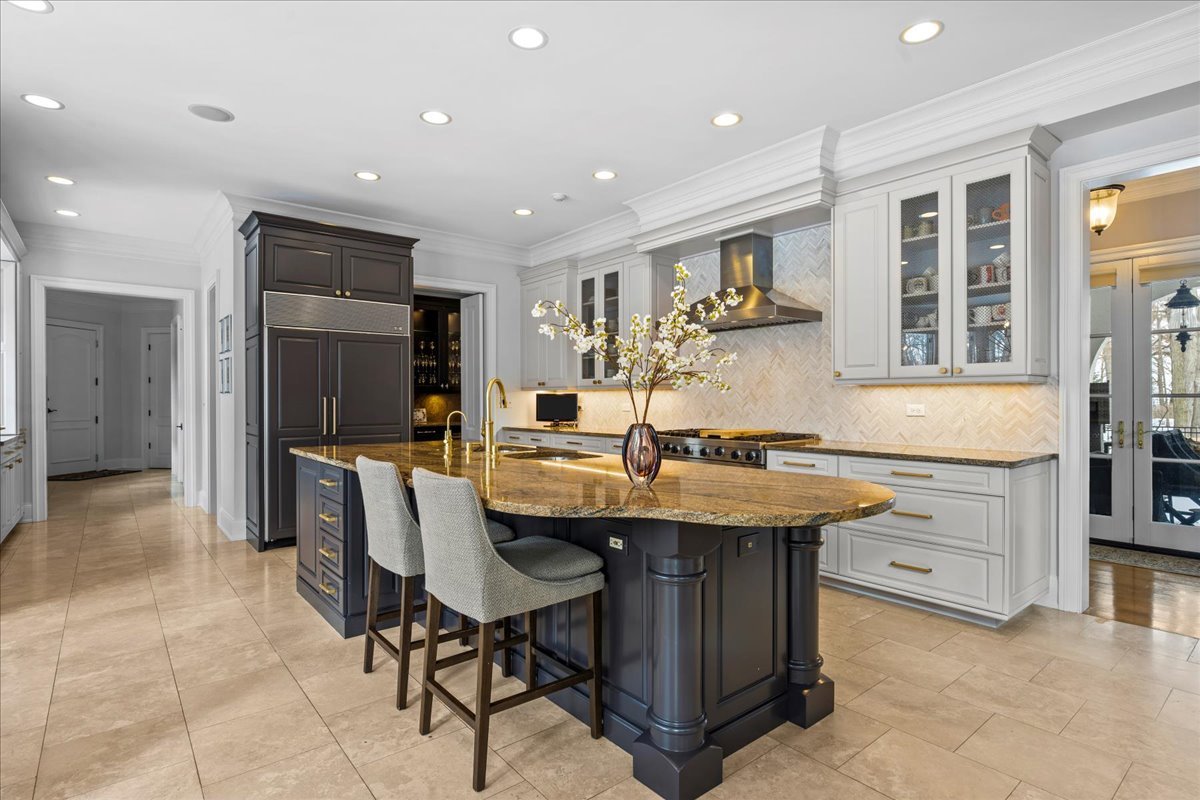 697 Bluff Road Lake Bluff, IL 60044 - Photo 12 of 49 a kitchen with a stove a sink a refrigerator and chairs