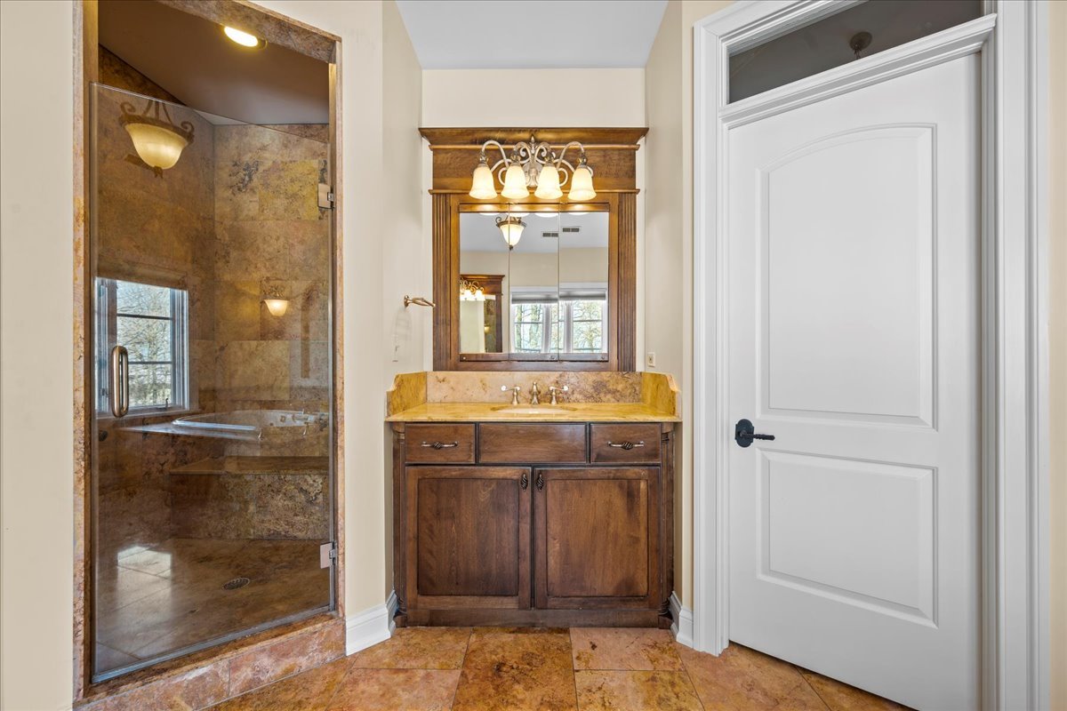 697 Bluff Road Lake Bluff, IL 60044 - Photo 24 of 49 a view of a bathroom with a sink and mirror