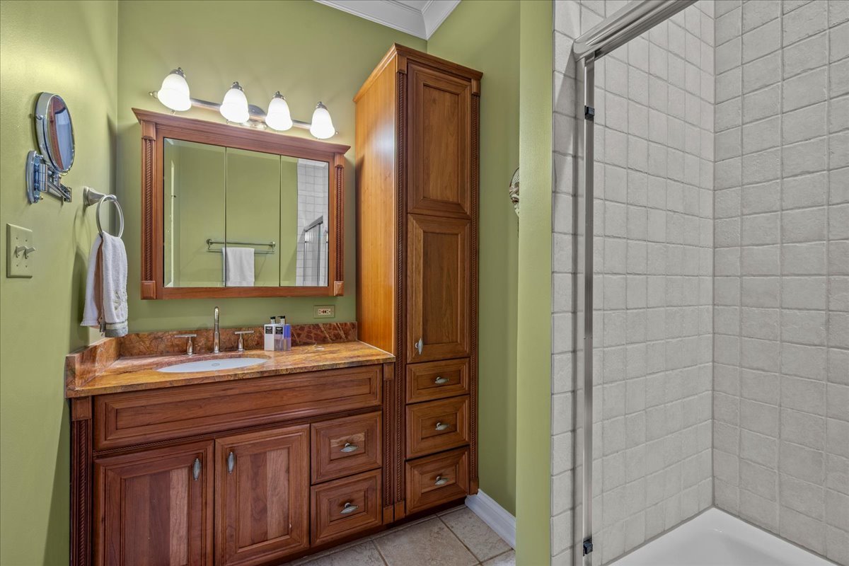 697 Bluff Road Lake Bluff, IL 60044 - Photo 31 of 49 a bathroom with a double vanity sink a mirror and a shower