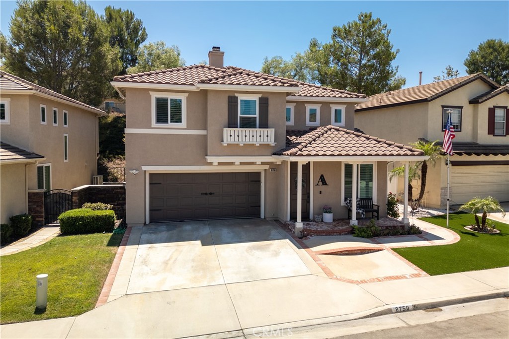 8750 East Heatherwood Road Anaheim Hills, CA 92808 - Photo 1 of 60 a front view of a house with a yard