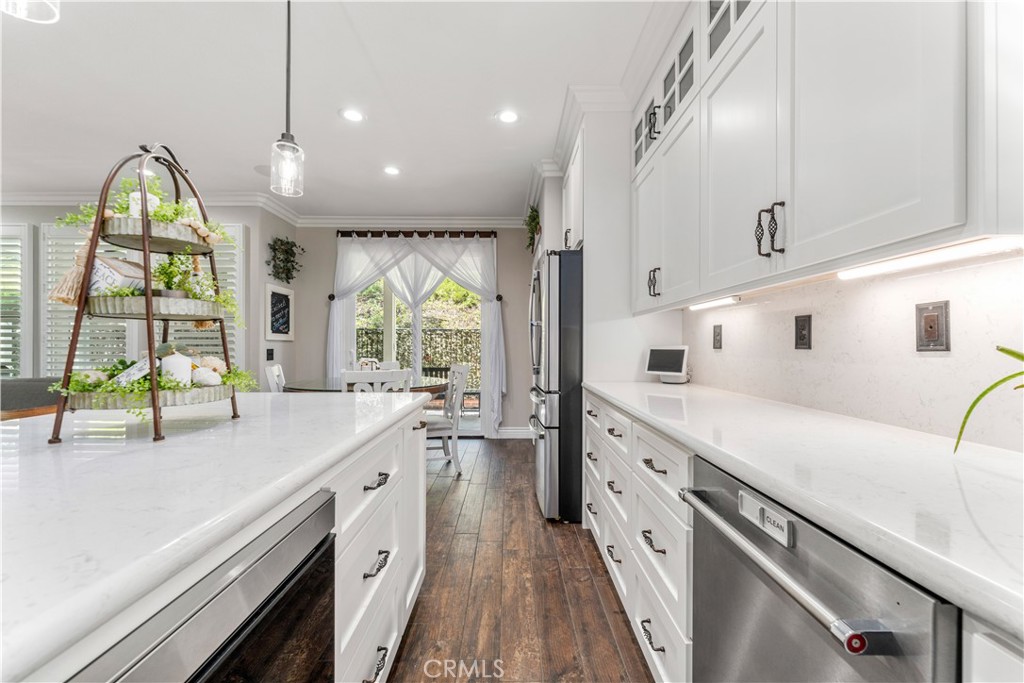 8750 East Heatherwood Road Anaheim Hills, CA 92808 - Photo 11 of 60 a large white kitchen with a large window
