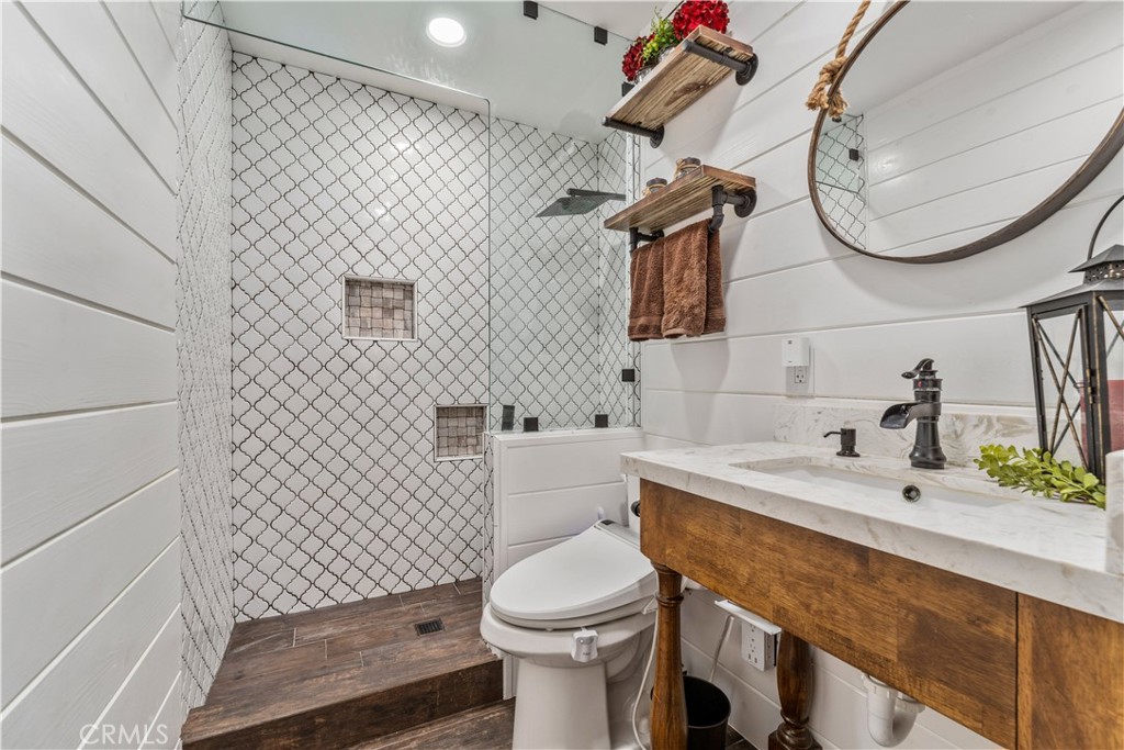 8750 East Heatherwood Road Anaheim Hills, CA 92808 - Photo 16 of 60 a bathroom with a sink a toilet and mirror