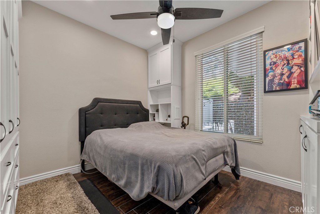 8750 East Heatherwood Road Anaheim Hills, CA 92808 - Photo 21 of 60 a bedroom with a bed and wooden floor