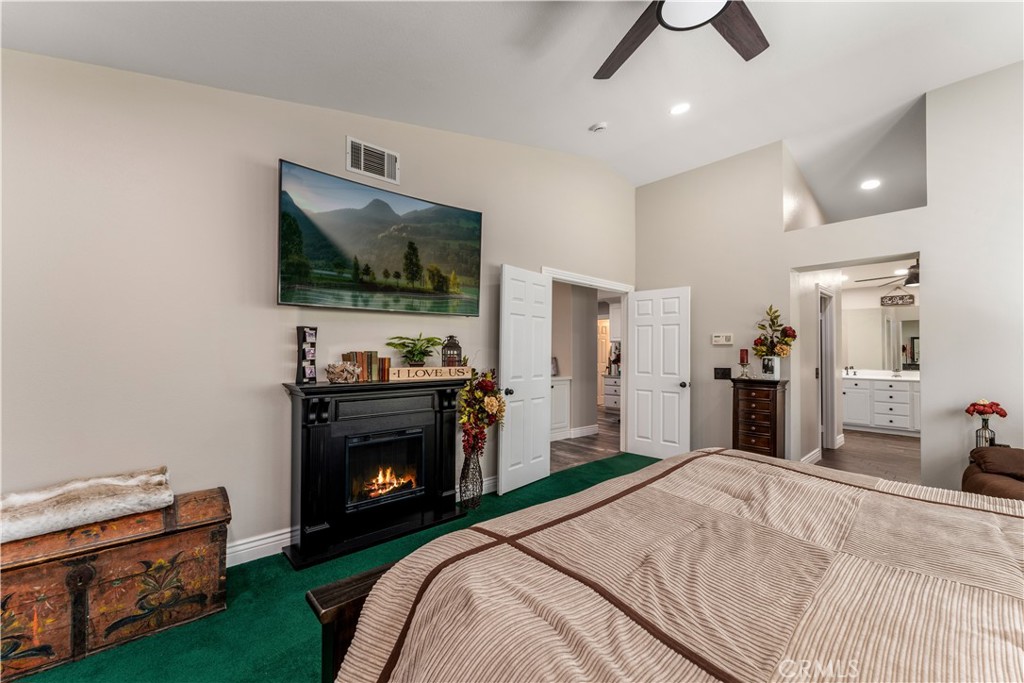 8750 East Heatherwood Road Anaheim Hills, CA 92808 - Photo 25 of 60 a bedroom with a bed and a flat screen tv