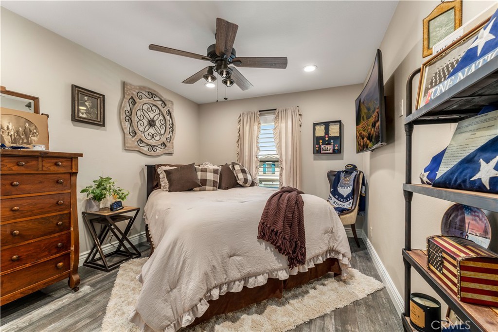 8750 East Heatherwood Road Anaheim Hills, CA 92808 - Photo 30 of 60 a bedroom with a bed and a chandelier