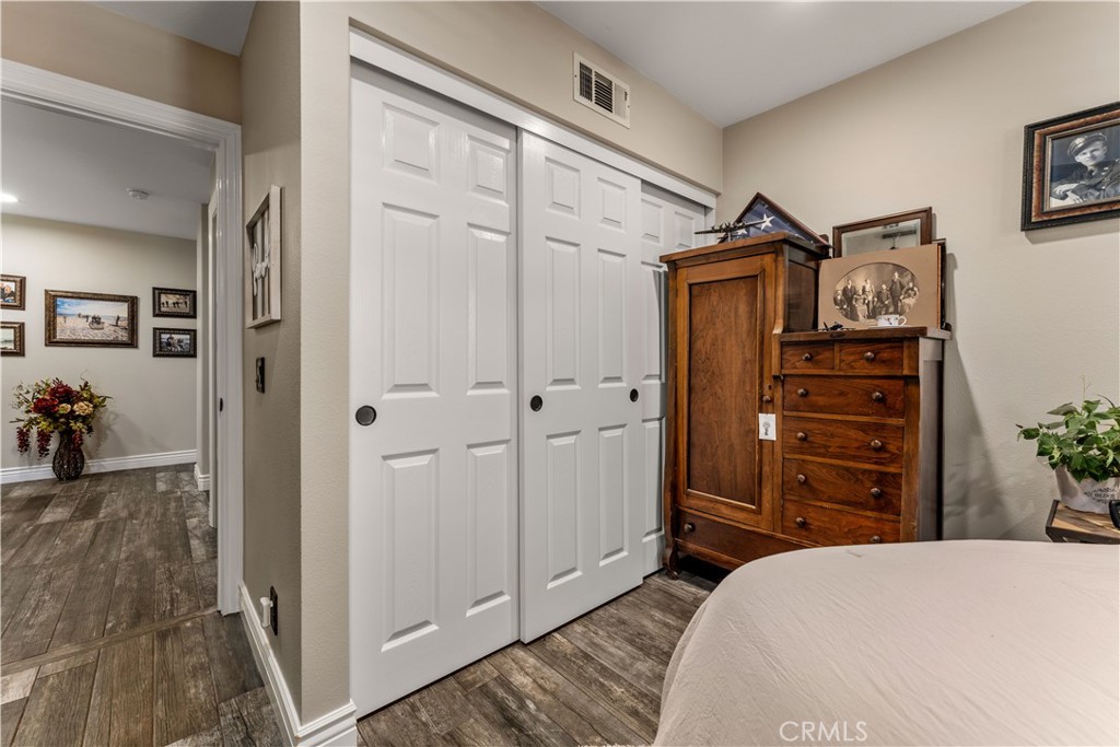 8750 East Heatherwood Road Anaheim Hills, CA 92808 - Photo 31 of 60 a bedroom with a bed and furniture
