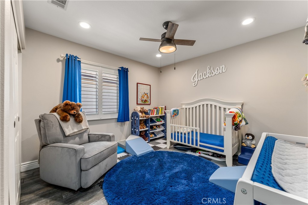 8750 East Heatherwood Road Anaheim Hills, CA 92808 - Photo 32 of 60 a living room with furniture a ceiling fan and a rug