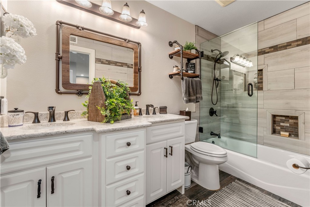 8750 East Heatherwood Road Anaheim Hills, CA 92808 - Photo 34 of 60 a bathroom with a sink a toilet and shower
