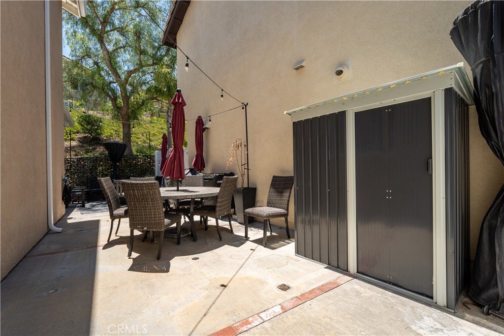8750 East Heatherwood Road Anaheim Hills, CA 92808 - Photo 45 of 60 a view of a patio with table and chairs and potted plants