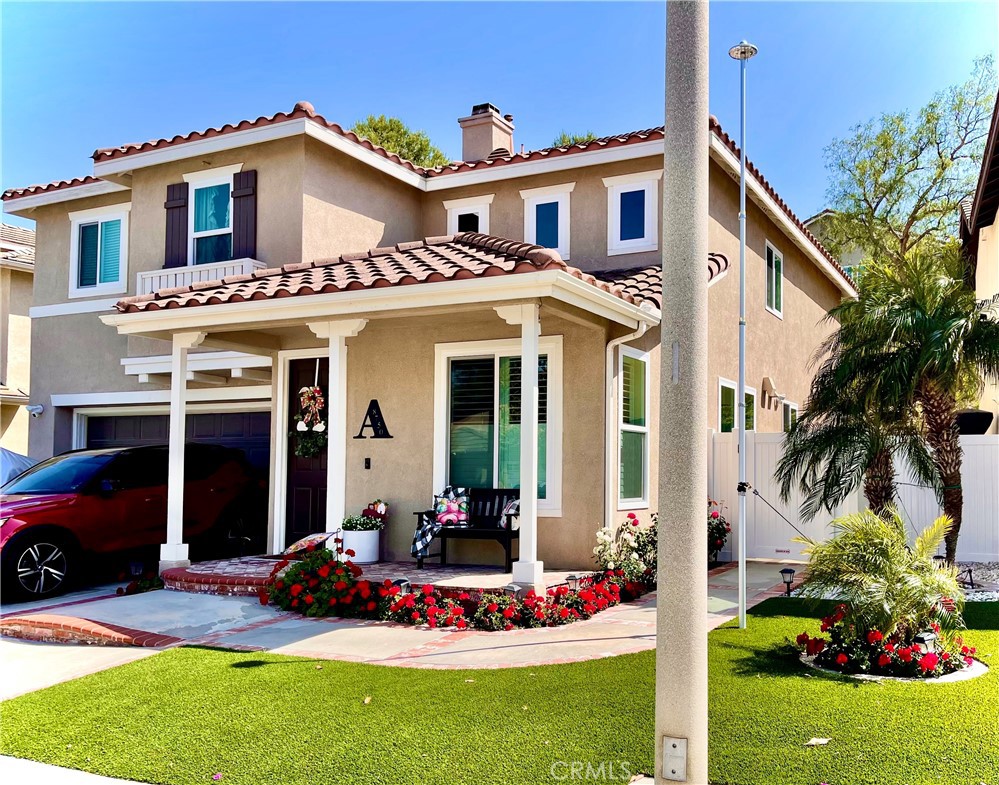 8750 East Heatherwood Road Anaheim Hills, CA 92808 - Photo 60 of 60 a front view of a house with a yard
