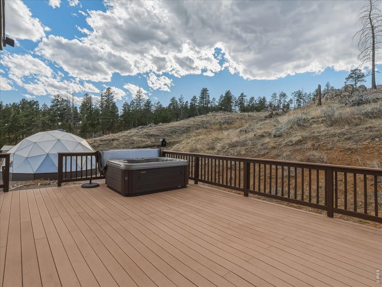 2565 Davis Ranch Road Bellvue, CO 80512 - Photo 39 of 50 Deck With Included Hot Tub Off Primary Bedroom. Easy Access to Greenhouse