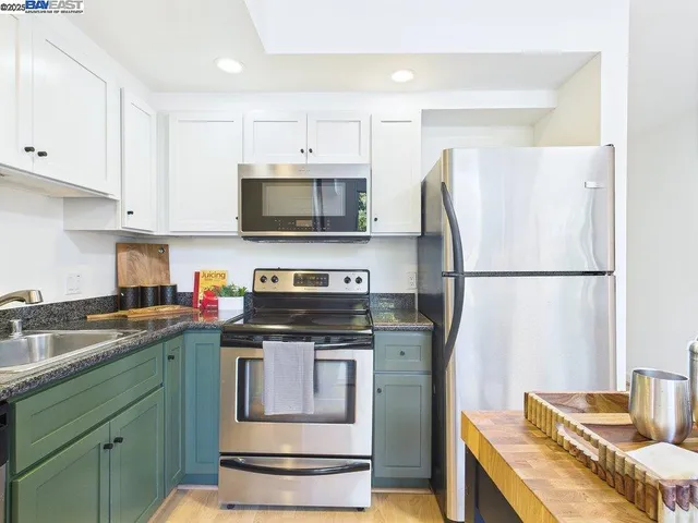 a kitchen with a appliances and cabinets