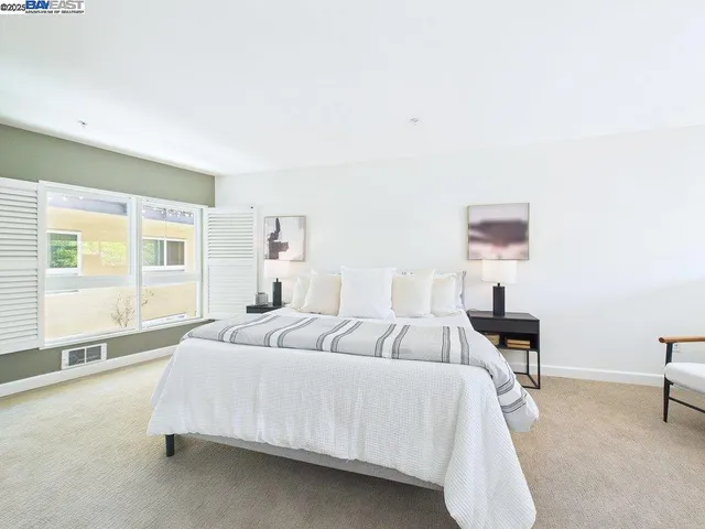 a bedroom with a bed and a lamp with window