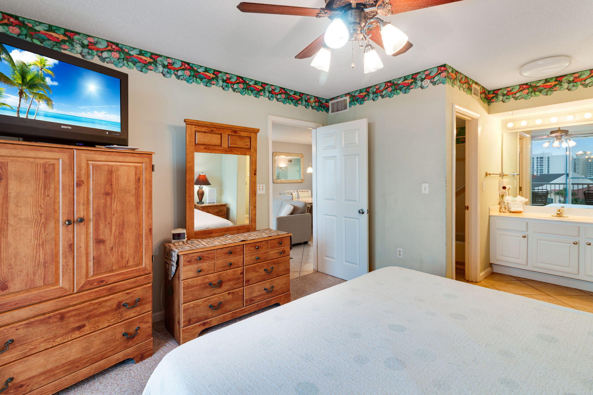 970 Highway 98, Unit 303 Destin, FL 32541 - Photo 25 of 42 a bedroom with a bed and a mirror