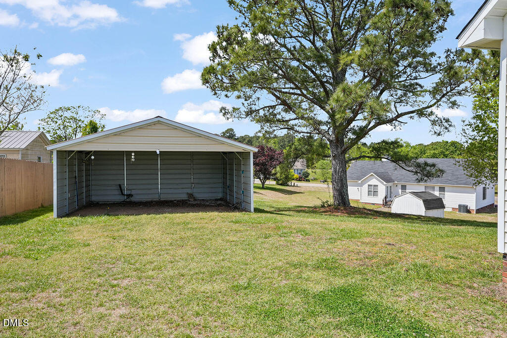1560 Cane Mill Road Coats, NC 27521 - Photo 27 of 32 a front view of a house with a garden and trees